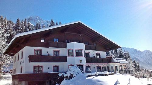 a large building in the snow with snow at Gästehaus Kristall in Kleinarl