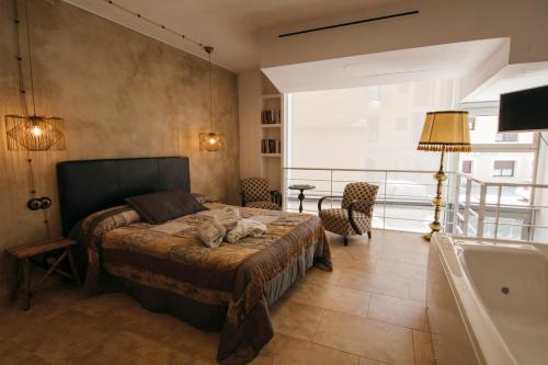 a bedroom with a bed with two cats laying on it at La Casa dels Abeuradors in Gandesa