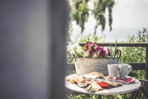 a plate of food on a table on a balcony at Teatro Deluxe Rooms in Kato Rodini