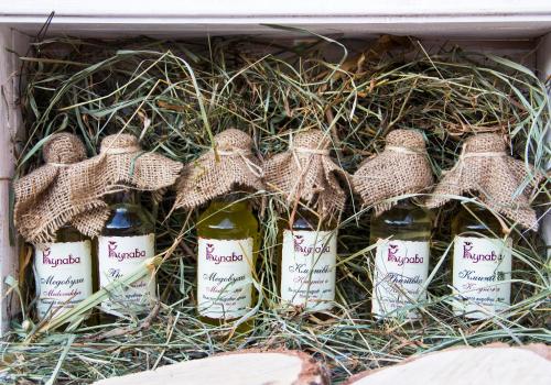 a box full of bottles of wine in hay at Deluxe Hotel Kupava in Lviv
