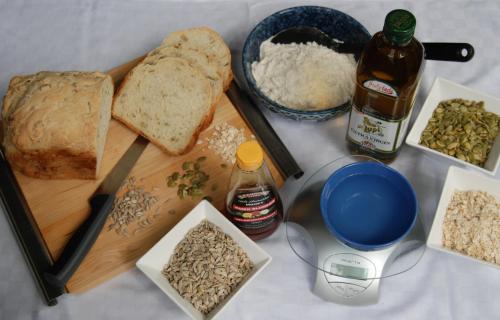 a table with a cutting board with bread and other ingredients at Witches Falls Cottages in Mount Tamborine