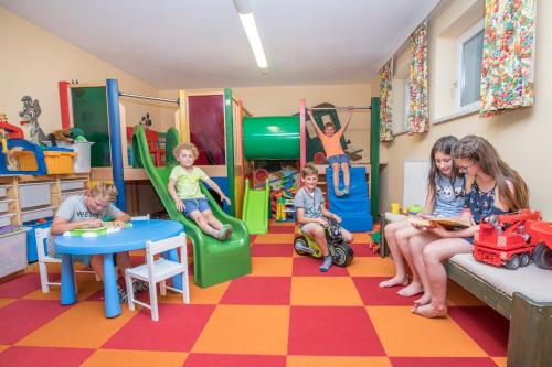 a group of children playing in a play room at Aparthotel Pichler in Flachau