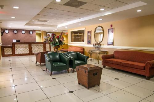 a waiting room with couches and a mirror at La Copa Hotel in McAllen