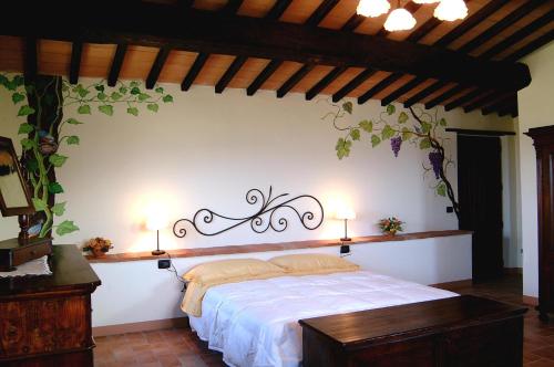 a bedroom with a bed with two lights on the wall at Agriturismo Casale delle Lucrezie in Todi