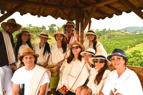 a group of people in hats posing for a picture at Finca del Café - Casa Typica in Santa Rosa de Cabal