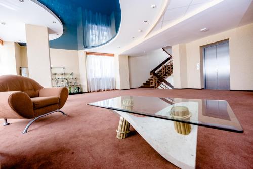a room with a glass table and a chair at Hotel Stal in Stalowa Wola