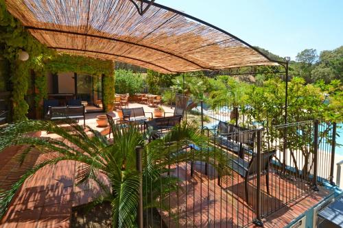 an outdoor patio with a fence and a pool at Résidence Les Pins in Calvi