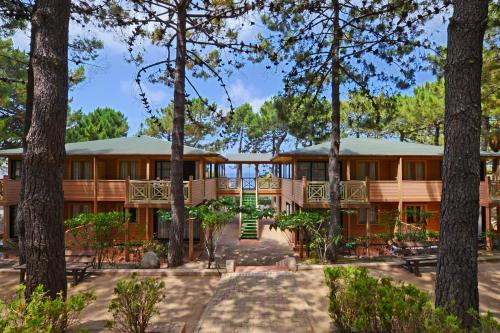 an exterior view of a house with trees at Résidence Les Pins in Calvi