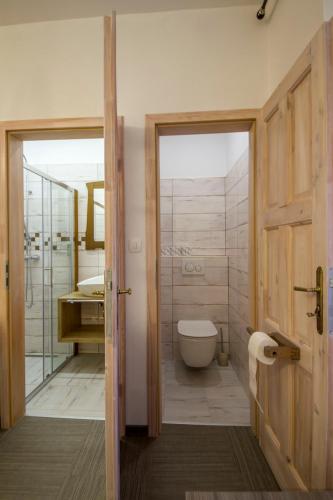 a bathroom with a tub and a toilet and a sink at OH Apartments & Rooms in Ljubljana