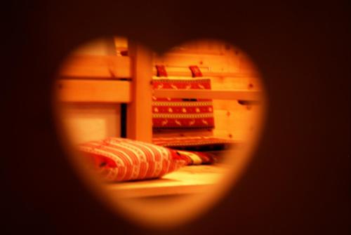 a door of an open refrigerator with some food at Ciasa Alpina Relax Hotel in Moena