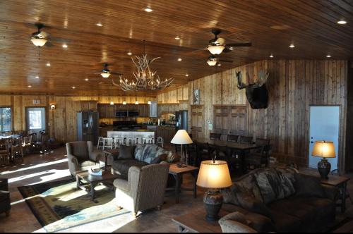 a living room with couches and tables and a kitchen at Lewis & Clark Resort in Yankton