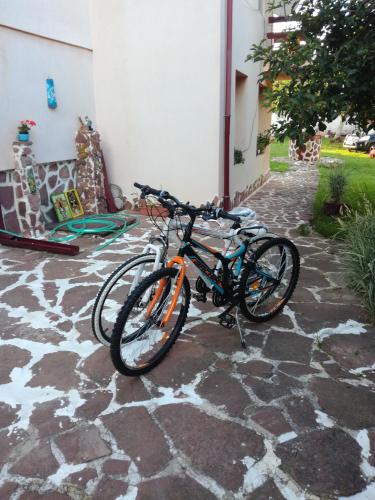two bikes are parked on a stone patio at Hadjibulevata Guest House in Kovachevtsi