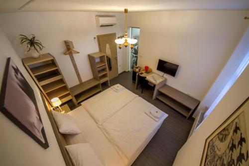 an overhead view of a room with a bed and a television at OH Apartments & Rooms in Ljubljana