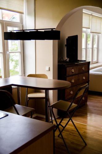 a living room with two tables and a dresser at Posti 19 Apartment in Haapsalu