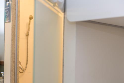 a shower in a bathroom with a shower curtain at ibis budget RJ Praia de Botafogo in Rio de Janeiro