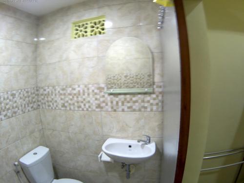 a bathroom with a toilet and a sink at Indy House in Ubud