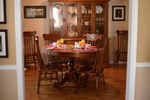 a dining room with a table with candles on it at Côté's Bed & Breakfast in Grand Falls