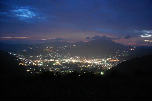 a view of a city lit up at night at Yufuin Country Road Youth Hostel in Yufuin