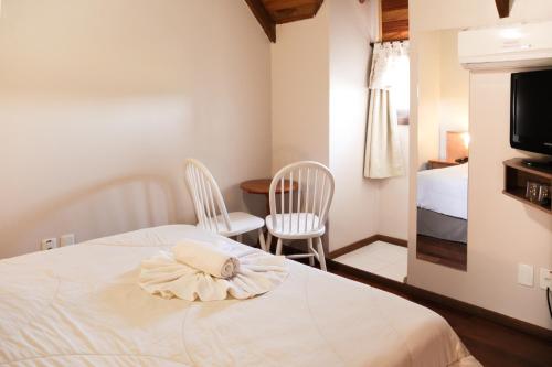 เตียงในห้องที่ Hotel Aconchego da Serra