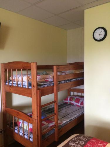 two bunk beds in a room with a clock on the wall at Lana House in Pärnu