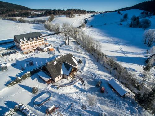 an aerial view of a house in the snow at Penzion pod Šerákem in Ostružná