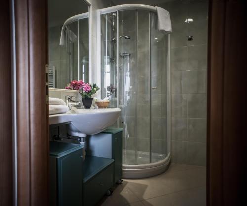 a bathroom with a sink and a shower at Lido Resort in Finale Ligure