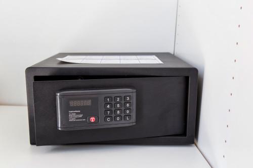 a microwave oven sitting on top of a white wall at Fivos Apartments in Aliki