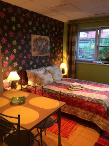 a bedroom with a bed and a table and two tables at Lana House in Pärnu