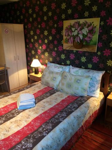 a bedroom with a bed with pillows on it at Lana House in Pärnu
