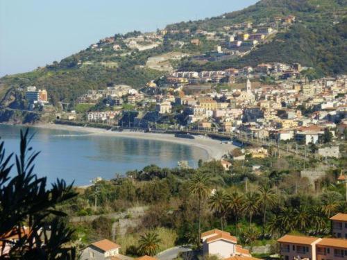 a town on a hill with a body of water at Mare Blu in Gioiosa Marea