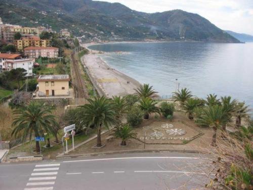 a view of a beach with palm trees and a body of water at Mare Blu in Gioiosa Marea