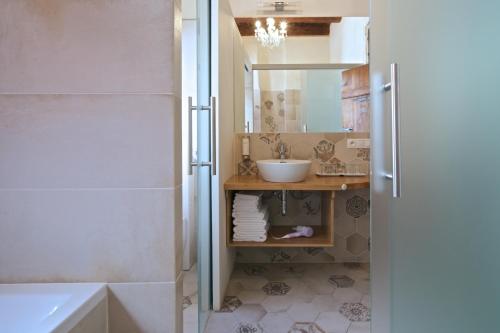 a bathroom with a sink and a tub and a sink at Residence U Mecenáše in Prague