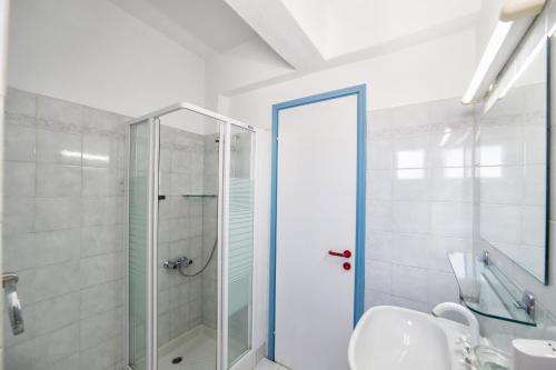 a bathroom with a shower and a sink at Fivos Apartments in Aliki
