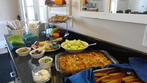 a table with a buffet of food and fruits at Anchor Inn Boutique Hotel in Put-in-Bay