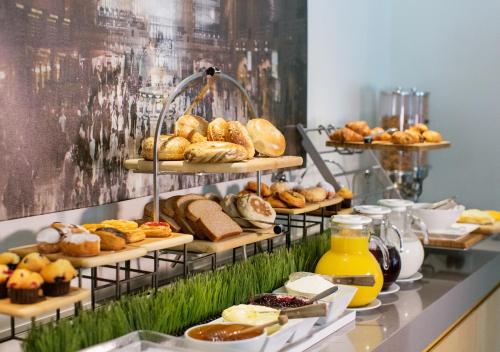 a display of bread and pastries on a counter at The Fifty Sonesta Hotel New York in New York