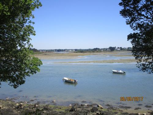 two boats sitting in the water on a river at Ty Cado in Belz