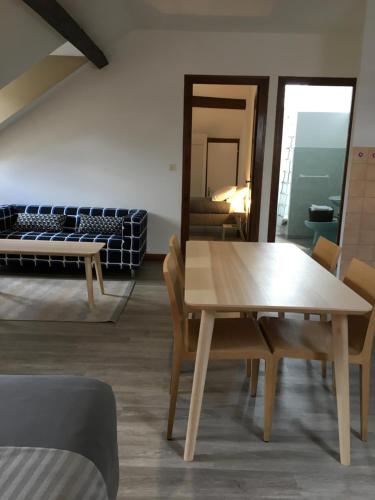 a room with a table and chairs and a bed at La Villa Esponda in Saint-Jean-Pied-de-Port