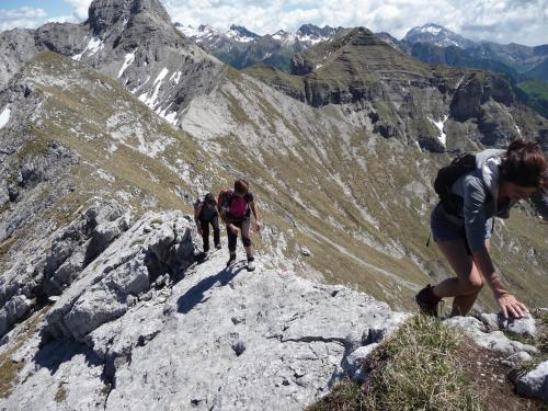 a group of people walking on a rocky mountain at Hotel Pedretti in Branzi