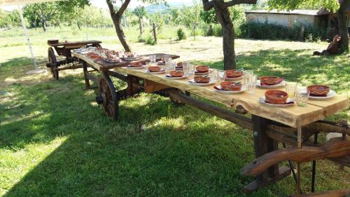 a long wooden table with food on top of it at Guest House Glogovac in Kamenica