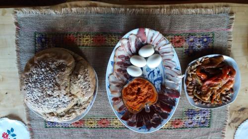 a table topped with plates of food on a table at Guest House Glogovac in Kamenica