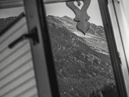 a view of a mountain through a window at Brückenhof in Finkenberg