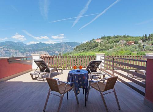 a patio with a table and chairs on a deck at Park Hotel Val Di Monte ***S in Malcesine
