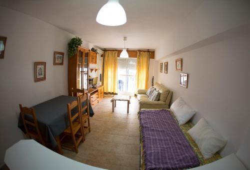 a living room with a couch and a table at Azucena in Garrucha