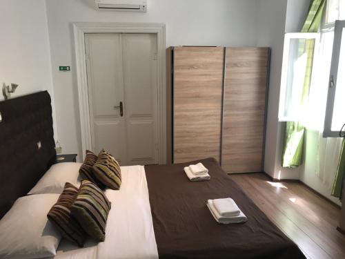 a bedroom with a large bed with two towels on it at Pula Antic Rooms in Center in Pula