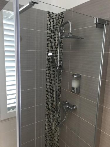 a shower with a glass door in a bathroom at Pula Antic Rooms in Center in Pula