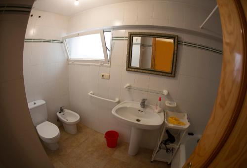 a bathroom with a sink and a toilet and a mirror at Azucena in Garrucha