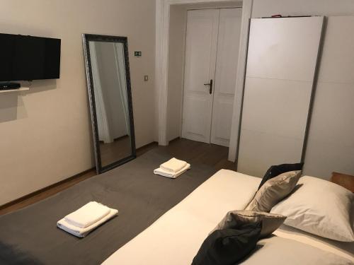 a bedroom with a bed and a mirror and a tv at Pula Antic Rooms in Center in Pula