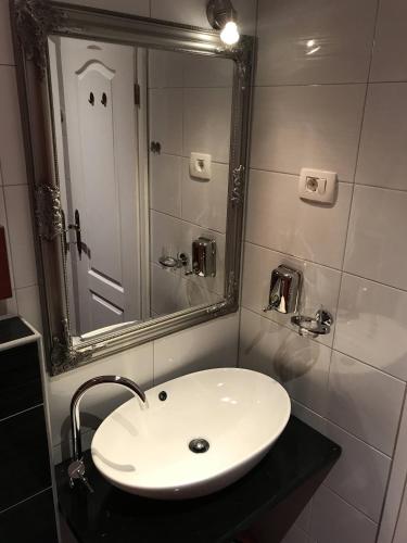 a bathroom with a white sink and a mirror at Pula Antic Rooms in Center in Pula