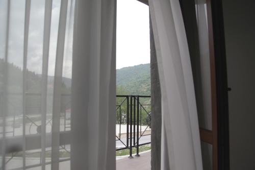 a room with a window with a view of a balcony at Hotel Korab Trnica in Trnica