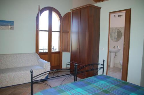 a living room with a bed and a couch at B&B Nuraximannu in Santadi